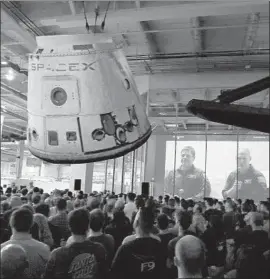  ?? Genaro Molina Los Angeles Times ?? NASA astronauts Bob Behnken, left, and Doug Hurley are projected on screen in August at the headquarte­rs of SpaceX, which occupies 10 buildings in Hawthorne.