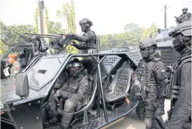  ??  ?? Indonesian special forces ride on a military vehicle during an anti-terror drill.