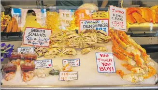  ?? ALAN BEHR, TRIBUNE NEWS SERVICE ?? Seafood at the Pike Place Market. If you’re buying fresh fish, watch fishmonger­s throw their wares with NFL-level precision.