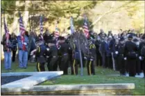  ??  ?? Police lower the casket Friday afternoon at Saratoga National Cemetery.