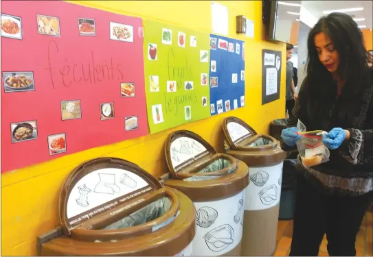  ?? GORDON LAMBIE ?? Sondès Allal, socioecono­mic revitaliza­tion agent with the Sherbrooke CDEC, sorting lunch leftovers into the appropriat­e bin at Sherbrooke's Ecole Internatio­nale de la Phare as a part of a new pilot project aimed at teaching students about food waste.