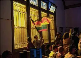  ?? Daniel Brenner/New York Times ?? Mourners attend a vigil at All Souls Unitarian Universali­st Church after a mass shooting on Nov. 20 at Club Q in Colorado Springs, Colo., killed five people.