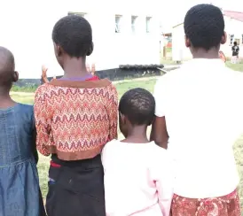  ??  ?? Precious Kurwa (right), a teen mother who is living with HIV stands with her siblings at the camp. She lost her medical records during the floods