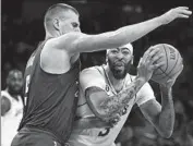 ?? Wally Skalij Los Angeles Times ?? NUGGETS CENTER Nikola Jokic pressures Anthony Davis as he tries to look for space in Game 3.