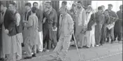  ?? AP ?? Afghan men line up to cast their votes, inside a polling station during the Parliament­ary election in Kabul on Saturday.