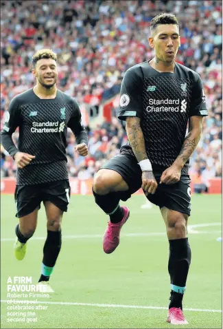  ??  ?? A FIRM FAVOURITE Roberto Firmino of Liverpool celebrates after scoring the second goal