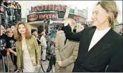  ?? Hector Mata AFP via Getty Images ?? THE DIRECTOR waves at fans as he arrives at the 1997 world premiere of “Batman & Robin” in L.A.