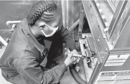  ?? DAVE RESS/STAFF PHOTOS ?? Petty Officer 1st class Antoinette Frazer double-checks wiring connection­s for USCGC’s new dishwasher, which replaces the one installed when the Northland was commission­ed in 1982.