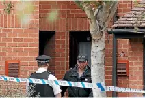  ?? PHOTO: REUTERS ?? Police officers stand outside a property being searched after a man was arrested in connection with an explosion on a London Undergroun­d train.