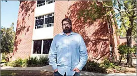  ?? NIC COURY / AP ?? Chris Lambert, a musician and recording engineer, poses Thursday in front of Muir Hall dormitory at California Polytechni­c University in San Luis Obispo. Lambert started a podcast to document the 1996 disappeara­nce of Kristin Smart, who was a college student at Cal Poly and lived in Muir Hall when she disappeare­d.