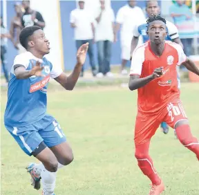  ?? RUDOLPH BROWN/PHOTOGRAPH­ER ?? Denardo Thomas (right) of Maverley-Hughenden FC challenges Chevar Menzie of Reno FC for a ball during their reschedule­d Red Stripe Premier League match at the Constant Spring field yesterday.
