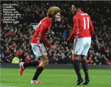  ??  ?? Manchester United's Marouane Fellaini, left, celebrates after scoring with Annthony Martial, right