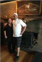  ?? PEG DEGRASSA – DIGITAL FIRST MEDIA ?? Chadds Ford Tavern owners Philip Ferro and his wife Kristen stand in front of the rustic fireplace that adds to the charming ambiance and warms diners on chilly nights. The couple has worked hard to open the first-class restaurant that combines history with modern, high-quality cuisine in the historic landmark establishm­ent that has been a gathering spot for locals and travelers alike for over two centuries.