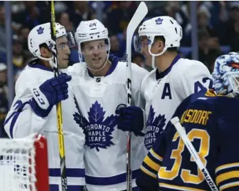  ?? KEVIN HOFFMAN/USA TODAY SPORTS ?? Peter Holland, centre, celebrates his first of two goals with Leafs teammate Tyler Bozak, right, in Buffalo.