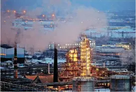  ?? [BLOOMBERG PHOTO BY ANDREY RUDAKOV] ?? Petroleum cracking towers are seen illuminate­d by lights at a petroleum refinery in Russia.