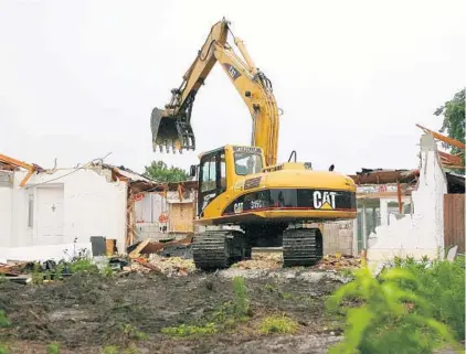  ?? SENTINEL FILE PHOTO ?? A house in DeBary is demolished in 2009. The city bought it through a FEMA program after it was damaged by floods in 2004 and 2008. The National Resources Defense Council has proposed a plan allowing repeated flood victims to sign up for a buyout...