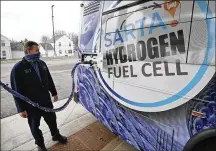  ?? TONY DEJAK / AP ?? Kevin Baker, a maintenanc­e technician, refuels a hydrogen fuel cell bus in Canton. Hydrogen is increasing­ly viewed as a vital answer to troubling questions about how to slow climate change.