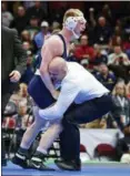  ?? DAVID DERMER — THE ASSOCIATED PRESS ?? Penn State’s Bo Nickal, top, celebrates with head coach Cael Sanderson after pinning Ohio State’s Myles Martin during the 184-pound championsh­ip match of the NCAA Division I Wrestling Championsh­ips, Saturday in Cleveland.