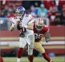  ?? THE ASSOCIATED PRESS ?? New York Giants quarterbac­k Eli Manning (10) is pressured by San Francisco 49ers defensive end Ronald Blair III (98) during an NFL football game in Santa Clara, Calif., Sunday, Nov. 12, 2017.