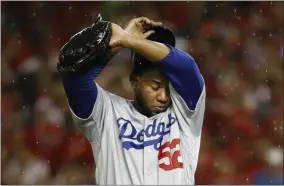  ?? PATRICK SEMANSKY - THE ASSOCIATED PRESS ?? Los Angeles Dodgers relief pitcher Pedro Baez (52) wipes his face after giving up a three-run home run to Washington Nationals first baseman Ryan Zimmerman during the fifth inning in Game 4 of a baseball National League Division Series, Monday, Oct. 7, 2019, in Washington.