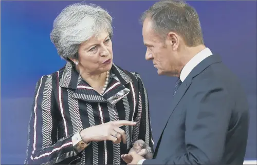  ??  ?? Theresa May speaks with European Council President Donald Tusk at a summit between EU and Asian leaders in Brussels.