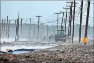  ?? PETER PEREIRA/THE STANDARD-TIMES VIA AP ?? The remnants of East Beach Road are damaged after heavy overnight winds and surf battered the coastline, Jan. 10 in Westport, Mass.