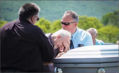  ??  ?? Walter Wilkins, 86, becomes emotional at the casket of his brother, Cpl. Paul Wilkins, at the end of his funeral.