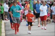  ?? MARIAN DENNIS – DIGITAL FIRST MEDIA ?? Eager participan­ts got a running start in their heels during the Walk a Mile in Her Shoes event held in Collegevil­le.