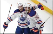  ?? GENE J. PUSKAR ?? The Edmonton Oilers' Darnell Nurse, right, celebrates with Connor McDavid after scoring Sunday in the third period.