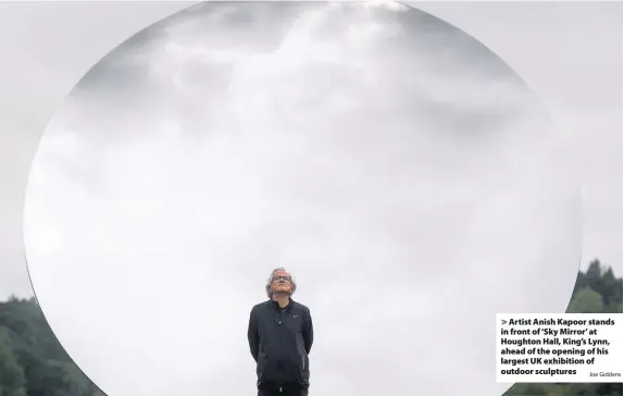  ?? Joe Giddens ?? > Artist Anish Kapoor stands in front of ‘Sky Mirror’ at Houghton Hall, King’s Lynn, ahead of the opening of his largest UK exhibition of outdoor sculptures