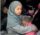  ?? AP ?? Children ride in the back of a truck evacuating people yesterday from the last territory held by Islamic State militants.