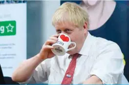  ?? — AFP ?? WATFORD: Britain’s Prime Minister Boris Johnson speaks to mental health profession­als during his visit to Watford General hospital in Watford, north of London yesterday.