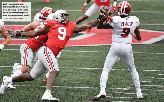  ?? Touchdown JAMIE SABAU/ GETTY IMAGES ?? Zach Harrison prevents Indiana QB Michael Penix Jr. from throwing. The Hoosiers fell short after clawing back from a four- deficit.