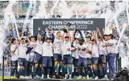  ?? Chris Szagola/Associated Press ?? The Philadelph­ia Union’s Kai Wagner, center, lifts the trophy as his team celebrates a win against New York City FC last October.