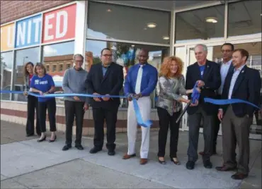  ?? ERIC BONZAR — THE MORNING JOURNAL ?? Bill Harper, executive director at United Way of Greater Lorain County, and Carrie Sechel, board president, cut the ribbon on the organizati­on’s new facility at 642 Broadway Ave., in Lorain, Sept. 7.