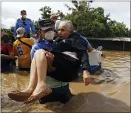  ?? THE ASSOCIATED PRESS ?? A National Police officer carries an elderly woman out of an area flooded by water brought by Hurricane Eta in Jerusalen, Honduras, Nov. 5.