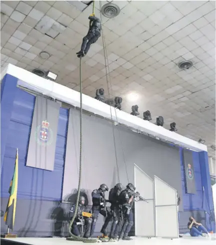  ?? (Photos: Naphtali Junior) ?? Members of the Jamaica Constabula­ry Force simulate a hostage rescue on the opening day of the police force’s inaugural expo at the National Arena in St Andrew last Thursday.