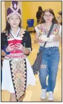  ?? (Special to NWA DemocratGa­zette/Mike Eckels) ?? Anna Xiong wears native Asian dress as she and Larea Echeverria tour the many displays and food stands set up during the celebratio­n.