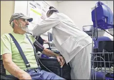  ??  ?? James “Ken” Dutton gets his blood pressure checked in Grady Hospital’s geriatric outpatient clinic. Georgia has just 135 doctors who are board-certified geriatrici­ans to care for a senior citizen population of 1.3 million.