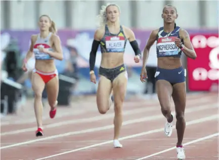  ?? (Photos: AFP) ?? Jamaica’s Stephenie-ann Mcpherson (right) on her way to winning the women’s 400m during the Diamond league British Grand Prix athletics event at Gateshead, north-east England, yesterday.