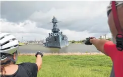  ?? Godofredo A. Vasquez / Houston Chronicle ?? Sara and Javier Montoya stop for a view of the 103-year-old Battleship Texas on Monday. Workers are trying to correct the ship’s tilt.