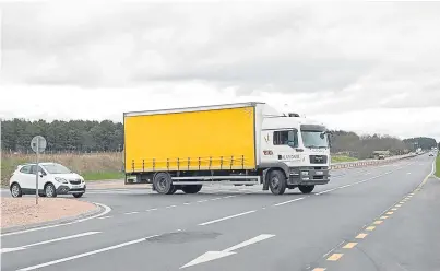  ?? Picture: Paul Smith. ?? A heavy goods vehicle negotiates the junction at North Water Bridge on the A90. Many lorry drivers consider it too dangerous and instead are taking an alternativ­e route through Edzell.