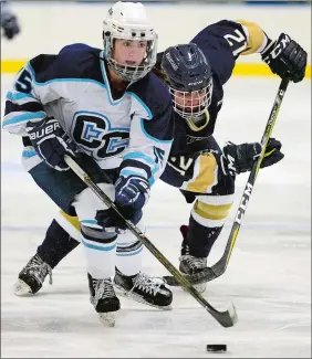  ?? SARAH GORDON/THE DAY ?? Connecticu­t College’s Elena Gualtieri (15) moves past Trinity’s Olivia White (12) during a women’s hockey game on Saturday at Dayton Arena in New London. Gualtieri scored a goal as Conn won 2-0. Please go to theday.com to view a photo gallery.