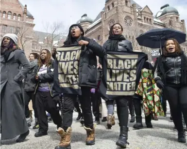  ?? LUCAS OLENIUK/TORONTO STAR ?? The Black Lives Matter demonstrat­ion travelled to Ontario’s Parliament building from Toronto Police Headquarte­rs Monday.