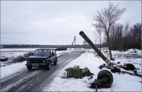  ?? ?? The Associated Press
A car drives past a destroyed tank at the former positions of Russian forces in Ridkodub village, Ukraine, Wednesday.