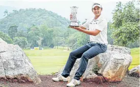  ??  ?? Nitithorn Thippong poses with the trophy after his victory yesterday.