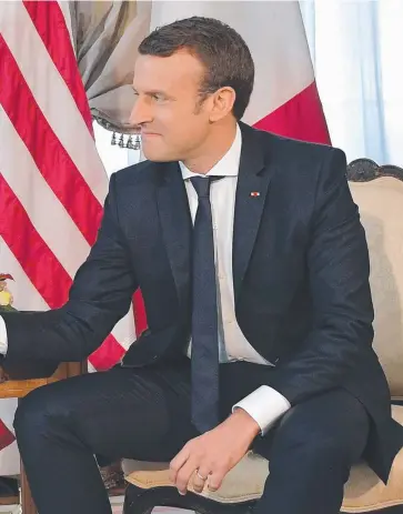  ??  ?? Macron, who supports globalisat­ion, shook hands awkwardly during their meeting in Brussels in May.