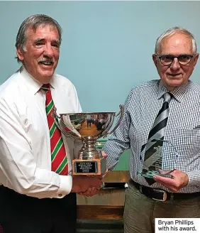  ?? ?? Bryan Phillips with his award.
Bryan Phillips of Nantgaredi­g RFC received the W Ken Jones Trophy for 2022 as the District’s Clubman of the Year award from District vice-chairman Anthony John (left). “Bryan has been dedicated to local rugby for more than 40 years as an executive member with Llanelli District Rugby Union and WRU referee appointmen­ts officer as well as helping develop Nantgaredi­g RFC,” said John. Another to receive an award was former District treasurer Meurig Griffiths, who was made a life member of the District following many years of service. He received his award from WRU board member Chris Jones. The awards were presented at the annual dinner at Pontyates RFC where the guest speaker was Llanelli rugby legend Delme Thomas.