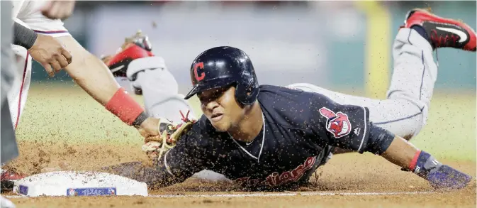 ?? — AP ?? ARLINGTON: Texas Rangers shortstop Elvis Andrus, left, tags out Cleveland Indians Jose Ramirez at third during the sixth inning of a baseball game Tuesday, in Arlington, Texas.