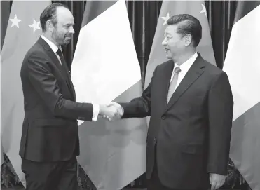  ??  ?? Chinese President Xi Jinping shakes hands with French Prime Minister Edouard Philippe in Beijing yesterday. Xi said China is willing to work with France to enrich the comprehens­ive strategic partnershi­p between the two countries. — Xinhua